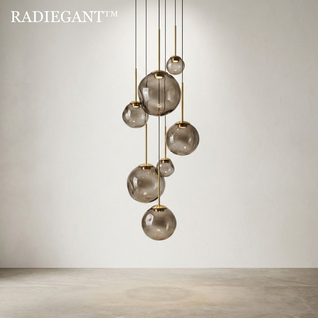 🌌 Radiegant™ THE AETHER CONSTELLATION CHANDELIER "To design light is to command the air itself. A cascading system of smoked glass and golden brass, engineered to bring the quiet, suspended drama of a nebula directly into your sanctuary."