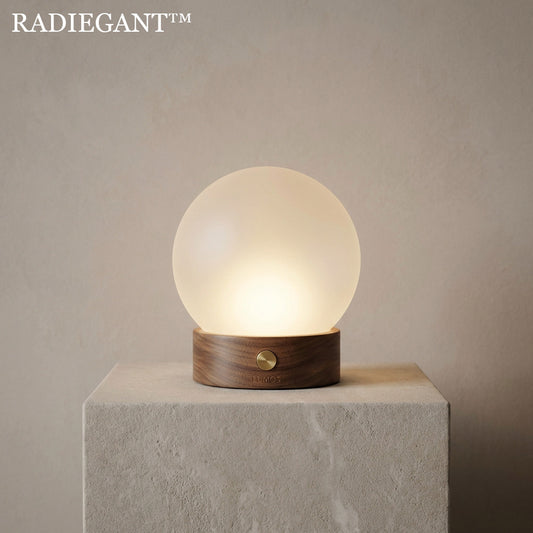 🌕Radiegant™ THE LUMOS SPHERICAL HEARTH "Before we engineered light to work for us, we gathered around it. The Lumos is a return to the origin of illumination—a warm, glowing sphere resting heavily on the timber of the earth."
